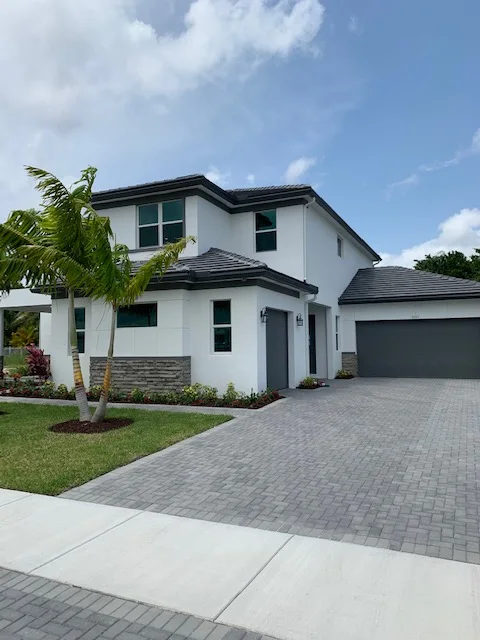Two-story Boynton Beach home with a modern exterior and garage